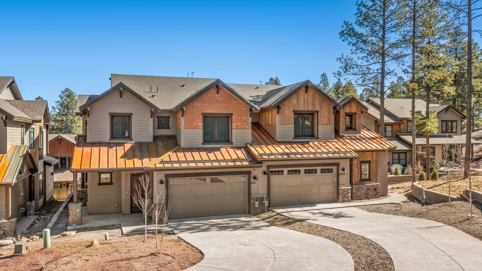 New home with a covered patio in a mountain setting